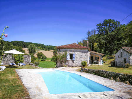 maison quercynoise en pierre avec une piscine  une jolie vue